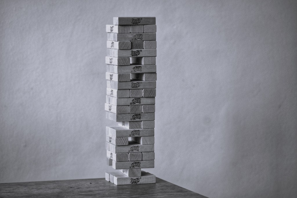 Black and white image depicting a construction in Jenga