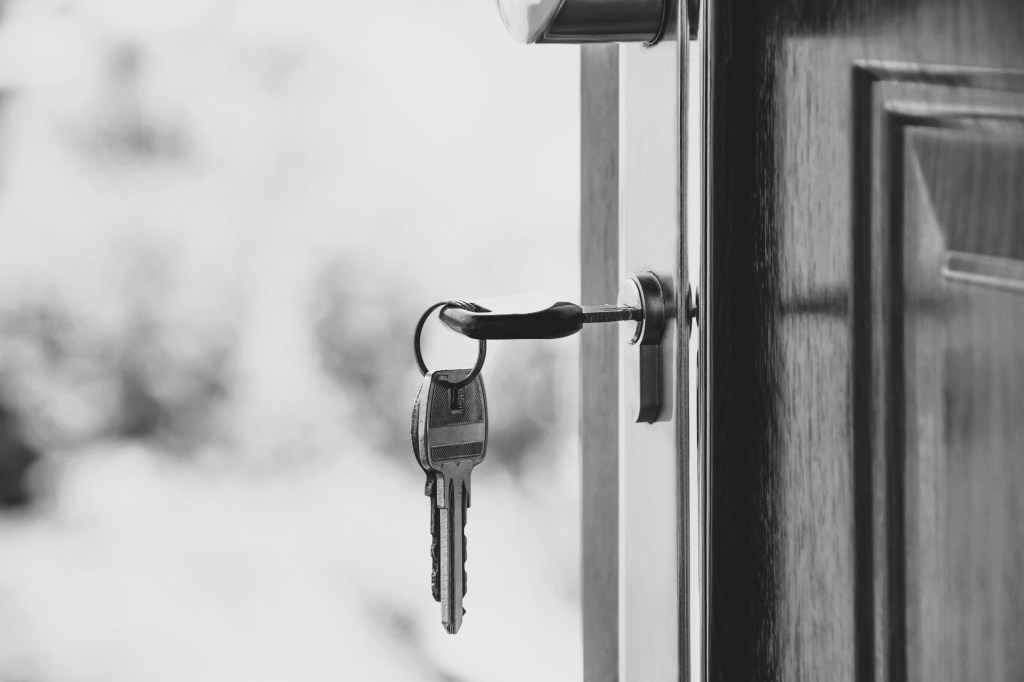 Black and white image representing a door with keys in the lock