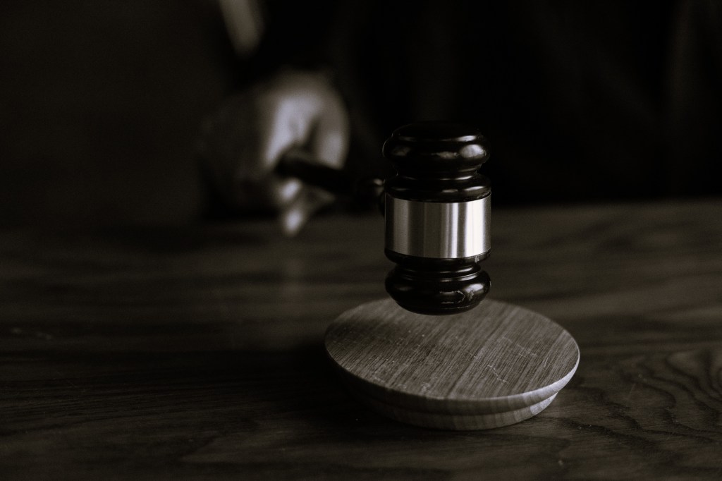A black-and-white image depicting the judge’s hammer
